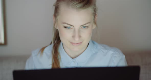 Smiling Woman Working on Laptop at Home Office. Businesswoman Typing on Computer Keyboard. alt