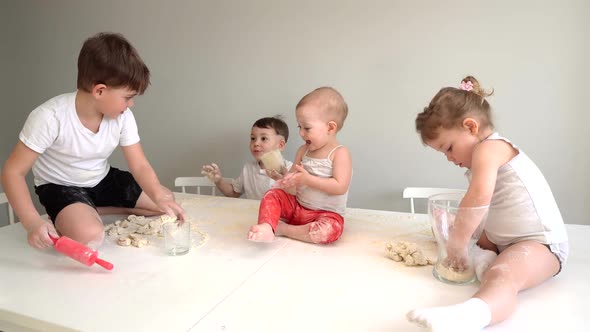 a Large Family, Many Children Prepare Cookie Dough in the Kitchen