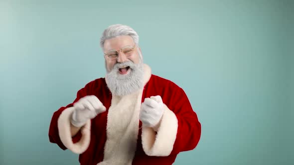 Funny Cheerful Santa Claus Blows Up Confetti Into the Air