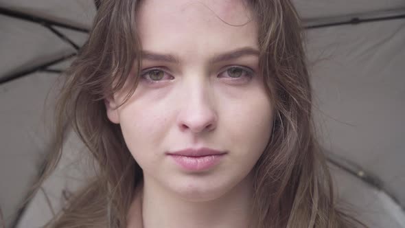 Close-up Face of Gorgeous Sad Woman Crying Outdoors on Rainy Windy Day. Portrait of Beautiful alt