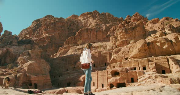 Female Tourist Visits Petra Taking Photo of Ancient Caves in Jordan Middle East
