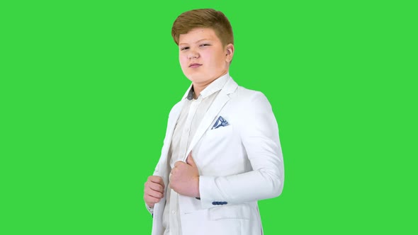 Confident Boy Model in White Suit Looking To Camera on a Green Screen Chroma Key alt