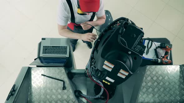 Maintenance Engineer Is Fixing Sailboat's Motor alt