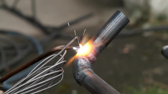 Worker welds pipe gas welding. Closeup. sparks flying around flame. fuel gases