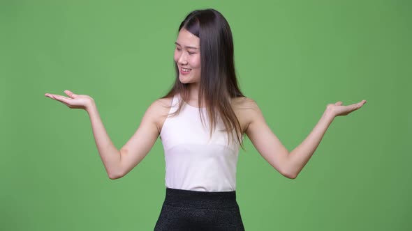 Young Beautiful Asian Businesswoman Choosing Between Left and Right