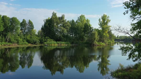 Flying Over Calm Summer Lake