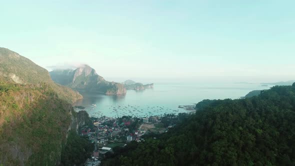 Aerial Drone Flight Between Mountains Covered with Tropical Forest on Sunrise Time alt