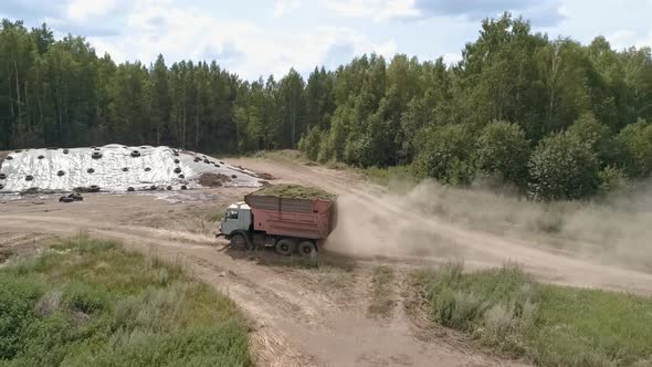 Aerial view of Truck bring haylage to the Silo Trench, tractors tamp the silage 13 alt