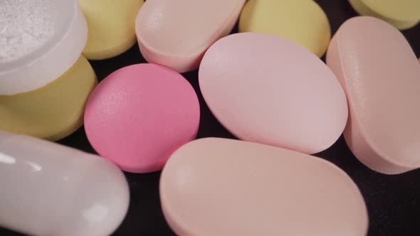 Closeup of a Set of Multicolored Pills Slowly Rotating alt