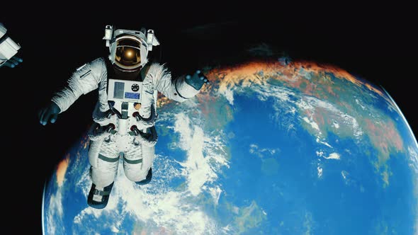 Astronaut in Outer Space Over the Planet Earth