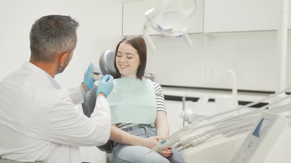 Lovely Young Woman Learning About Dental Care From Her Dentist
