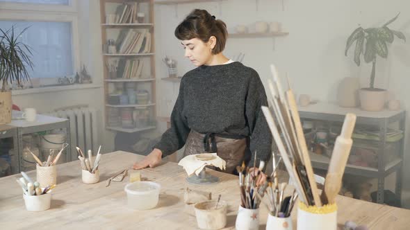 Young woman working with clay and ceramics