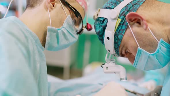 Surgeons' faces at work. alt