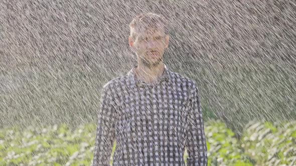 Portrait of Sad Man Standing Under the Rain. Super Slow Motion alt
