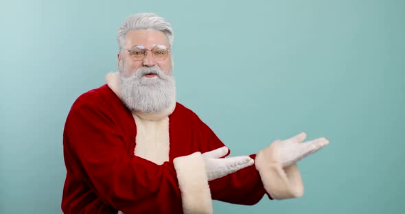 Stylish Cheerful Trendy Santa Claus Posing Isolated on Blue Color Background Studio