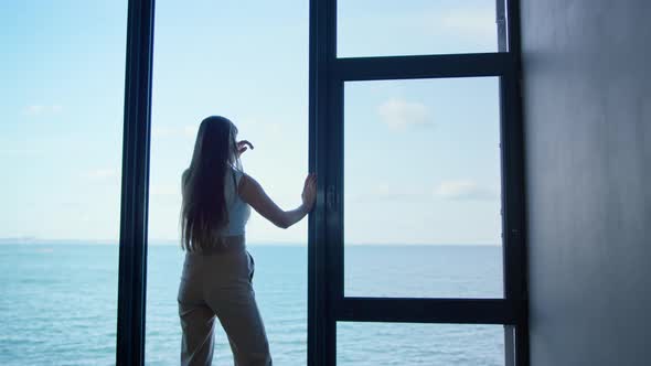 Lonely Woman Thinking Problems at Panorama Window alt