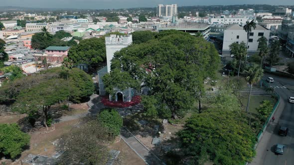 Aerial footage of Saint Michael's Church hidden behind trees in Bridgetown, Barbados alt