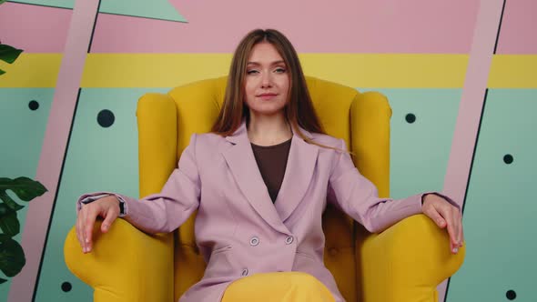 Bossy Woman Is Sitting In Yellow Armchair