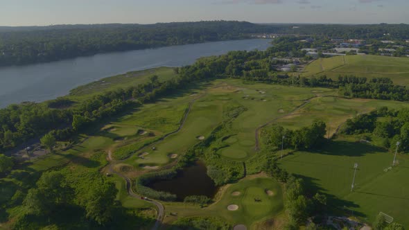 Aerial of a Golf Course by the Water on a Sunny Day in Long Island alt