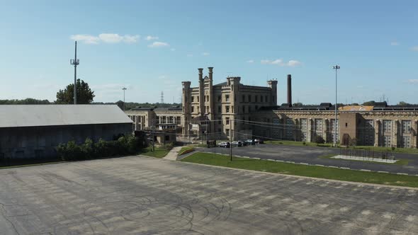 Aerial view of the old and abandoned Joliet prison or jail, a historic site. Drone flying up from a alt