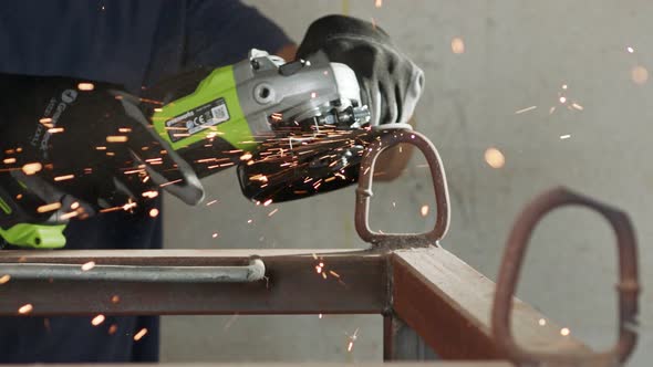 Slow motion of a metal grinder during work with sparks flying alt