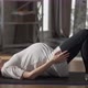 Side View Concentrated Pregnant Sportswoman Raising Hips Lying on Exercise Mat at Home - VideoHive Item for Sale