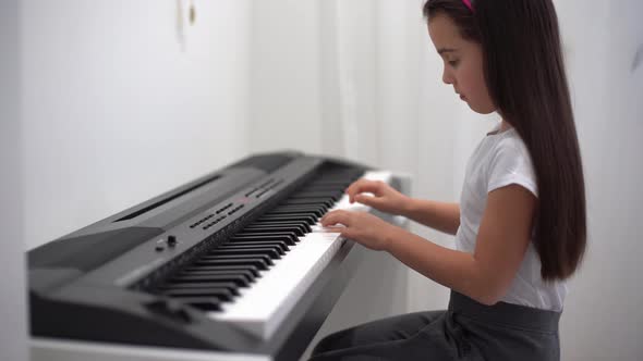 Cute Little Girl Has Training Course with Piano alt