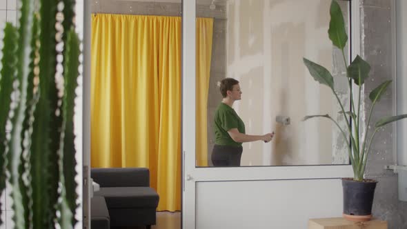 Woman Paint Wall in Her Room in Grey DIY Home Repair alt