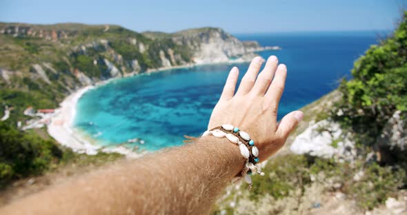 Man Hand Streached in the Air Towards Beautiful Beach alt