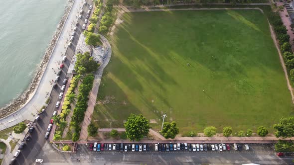 Aerial dolly view green tree shadow of Padang Kota Lama Esplanade alt