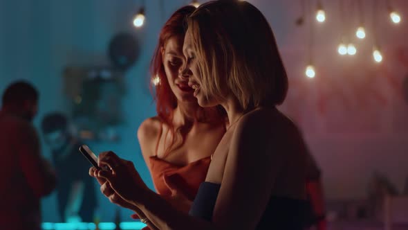 Women Using Smartphone During Party alt