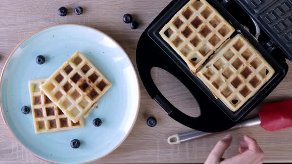 Waffles Being Baked in the Waffle Maker. Savory waffles. Breakfast concept. alt