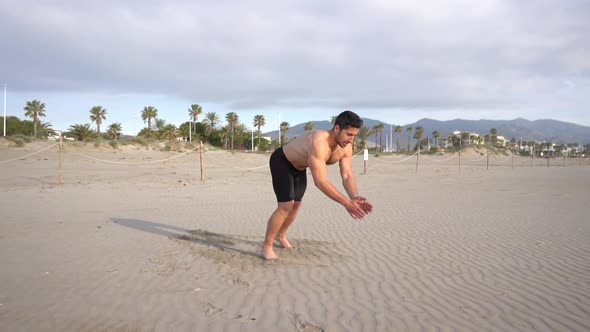 training variant of push-ups with slap on beach with palm trees in the ...