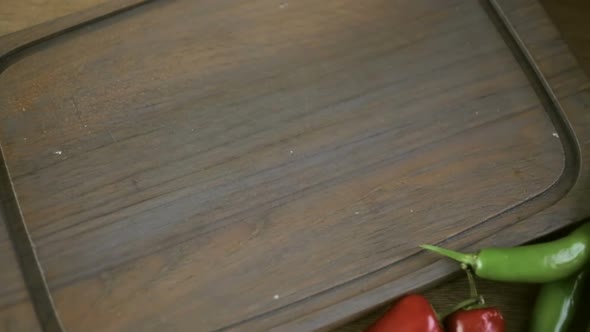 Slicing Jalapeno Pepper on a small cutting board. alt