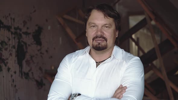 Portrait of a Brutal Young Man with a Beard That Laughs and Frowns Closeup alt