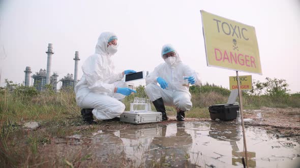 Team of Environmental scientists took a sample of water for analysis. alt