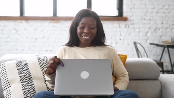 Multiracial Young Woman Spending Home Leisure with Laptop
