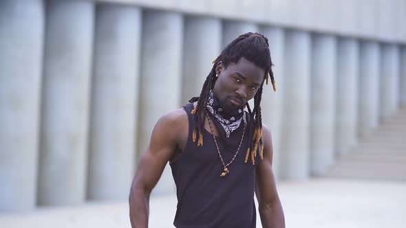 Serious African American Men Looks at Camera and Threatens with a Baseball Bat alt