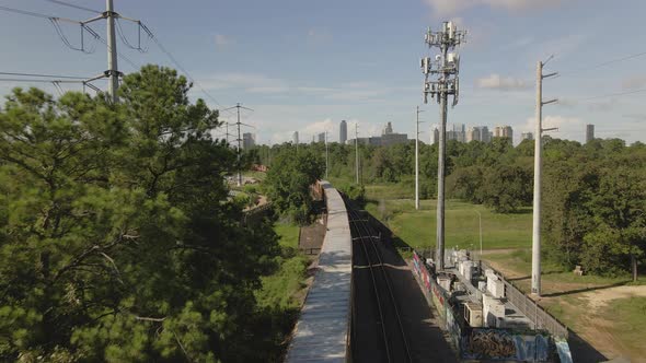 Aerial view of cargo train heading towards de city of Houston, Texas, USA. alt