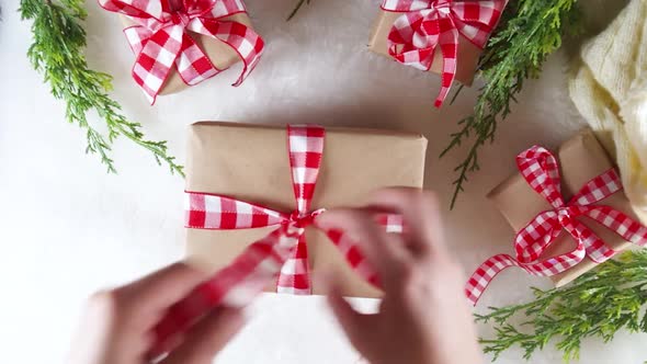 Woman hands decorate Christmas new year gifts