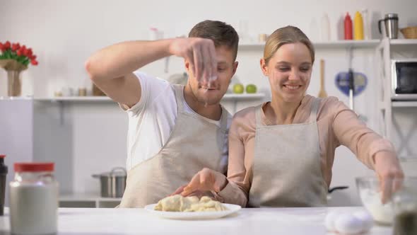 Happy Couple Clumsily Kneading Dough, Spending Fun Time Together in Kitchen alt