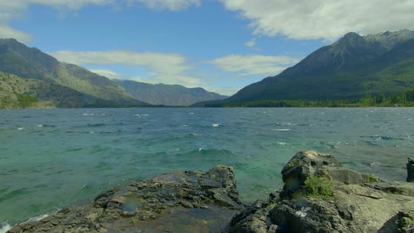 Turquoise rough waters on a  windy day. Emerald Lake Epuyen Patagonia Argentina. Slider slow move. p alt