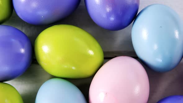 Multicolored Easter eggs on wooden surface alt