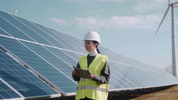 Close Up of Female Ecological Engineer Checking the Operation of Solar Panels