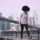 Female fitness model training outside in New York City with skyline and Brooklyn Bridge  - VideoHive Item for Sale