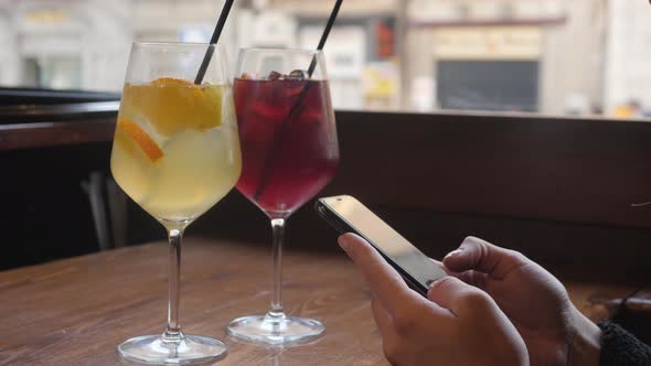 Traveler Woman Drink Sangria and Using Smartphone in Spanish Cafe Girl with Phone Use Application alt
