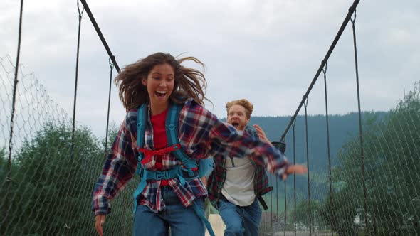 Two Travelers Have Fun on Mountains Bridge alt