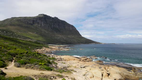 Aerial view of clear Atlantic ocean Llandudno coastline, Cape Town, South Africa. alt