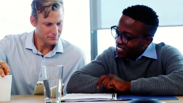 Executives discussing reports alt