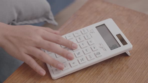 Close up shot of businesswoman or female accountant hand using a calculator